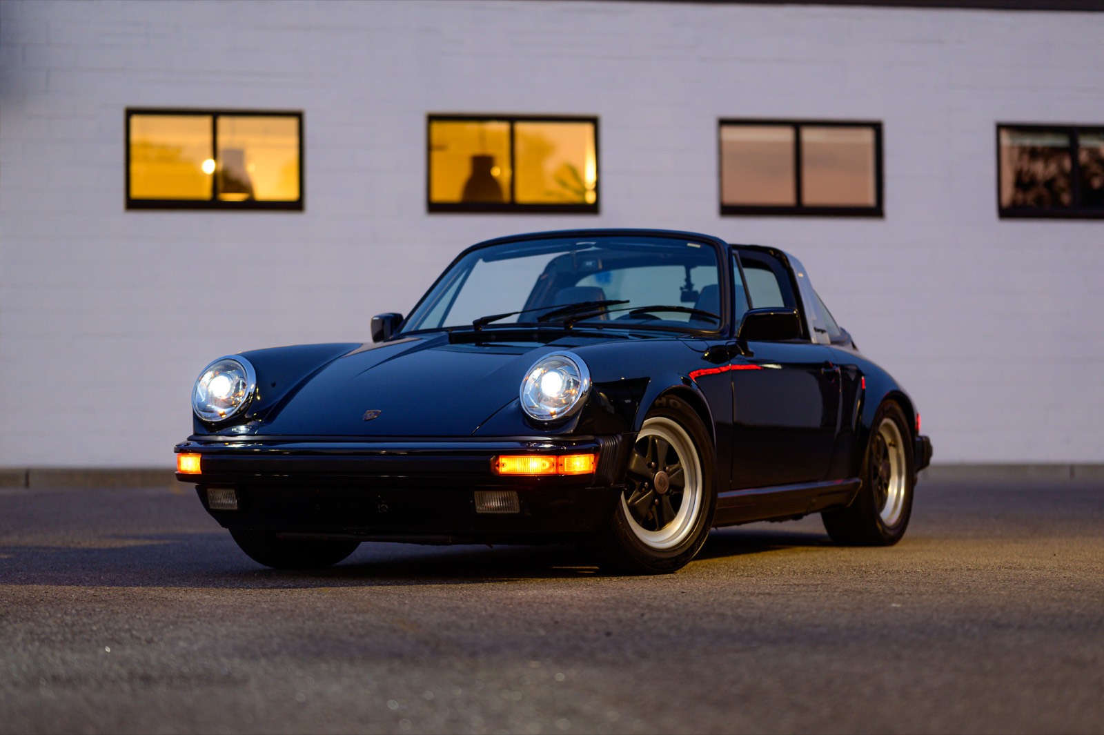 A black Porsche 911 Targa at dusk